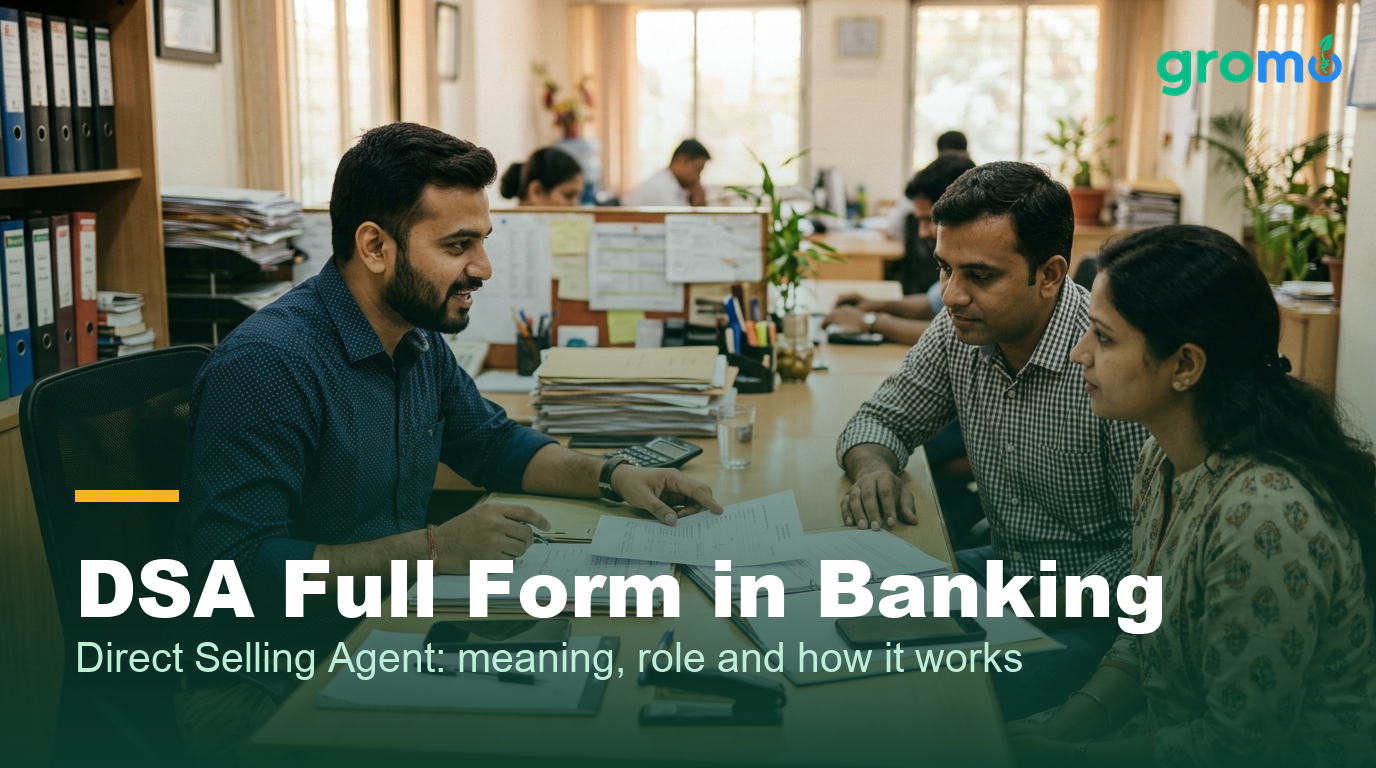 Indian DSA agent explaining loan documents to a customer couple in a small office