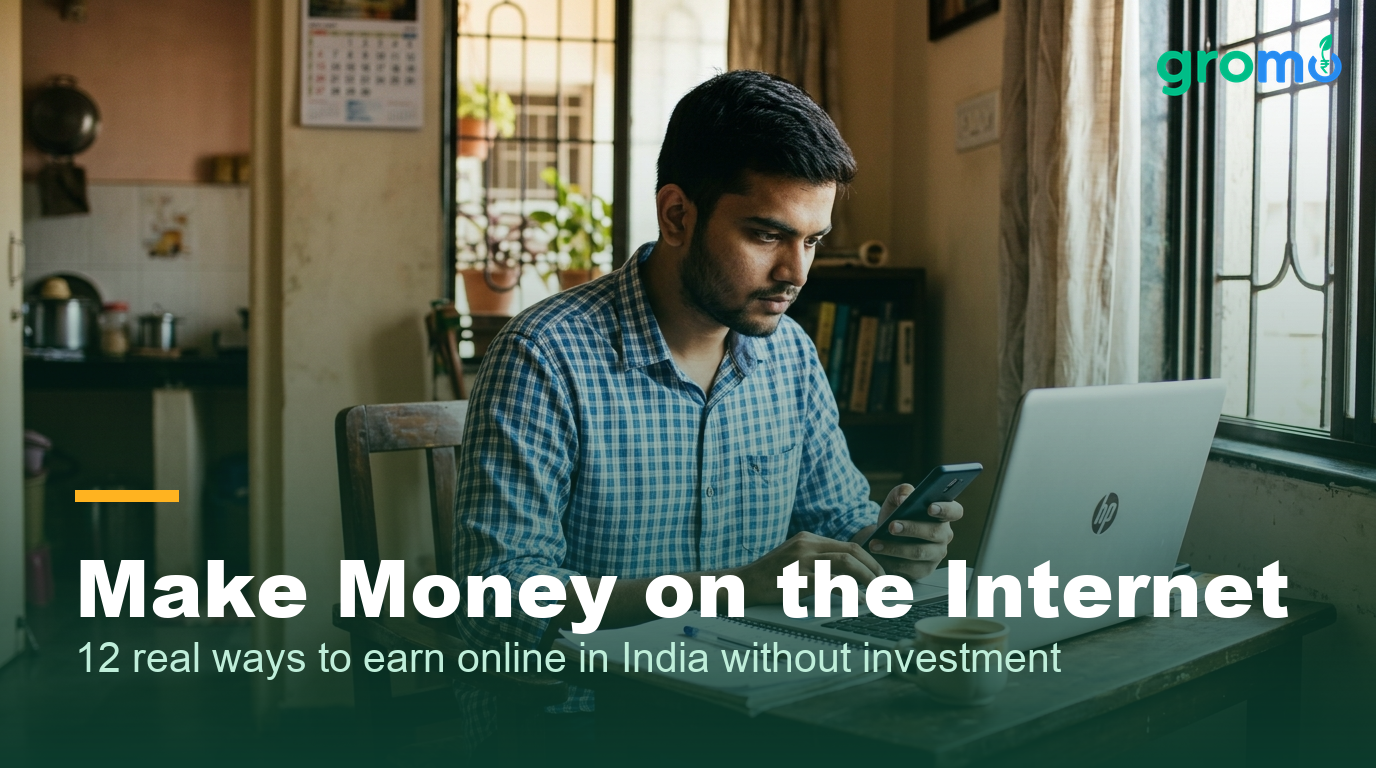 Young Indian man earning online with a smartphone and laptop at home