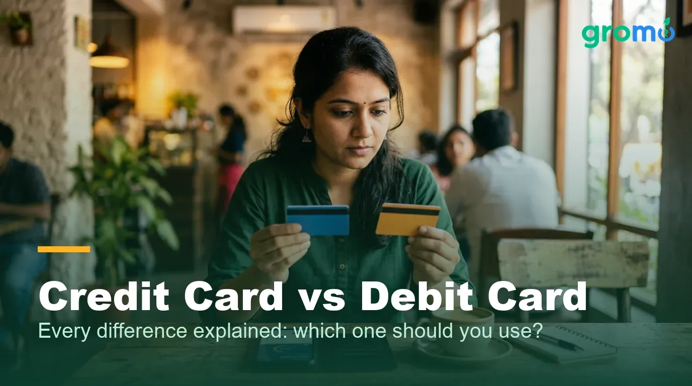 Indian woman comparing a credit card and a debit card side by side