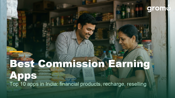 Indian shop owner earning recharge commission by helping a customer on his smartphone