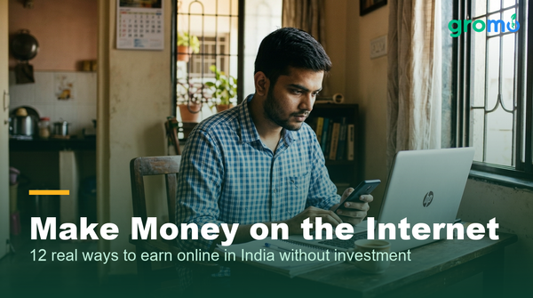 Young Indian man earning online with a smartphone and laptop at home