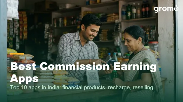Indian shop owner earning recharge commission by helping a customer on his smartphone