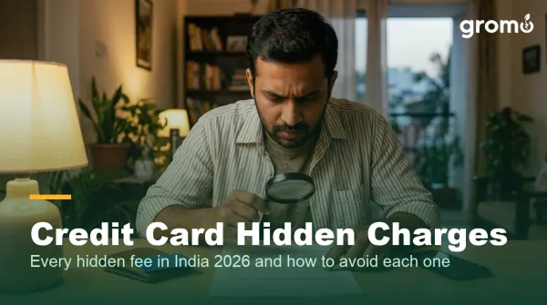 Indian man examining his credit card statement for hidden charges at home