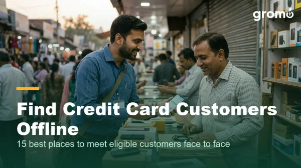 Indian credit card agent talking with a shop owner at an electronics store counter