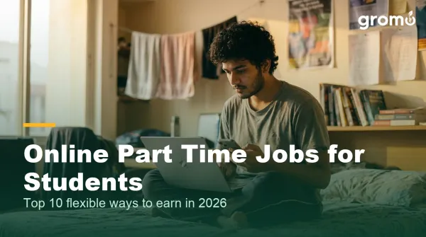 Indian student doing an online part time job from his hostel room with laptop and phone